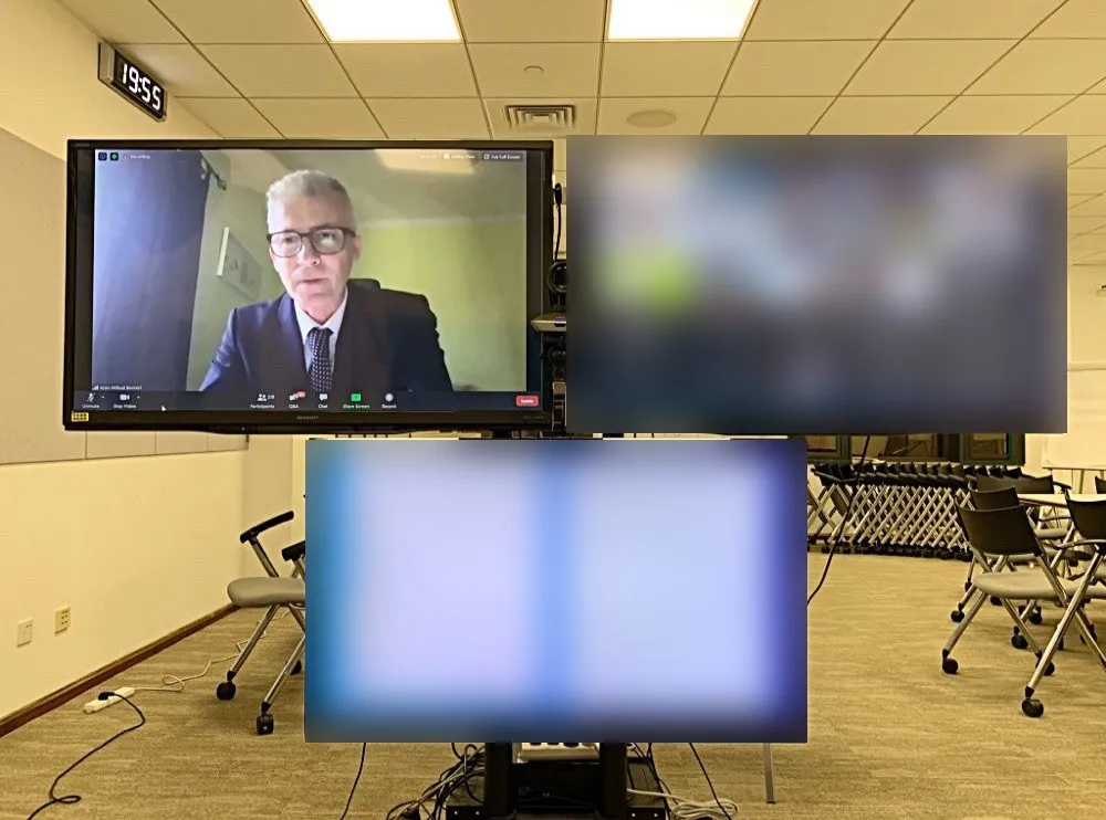 The panel in the CEIBS conference room: Dr Aron Mifsud Bonnici speaking on the main screen during the online Executive Forum